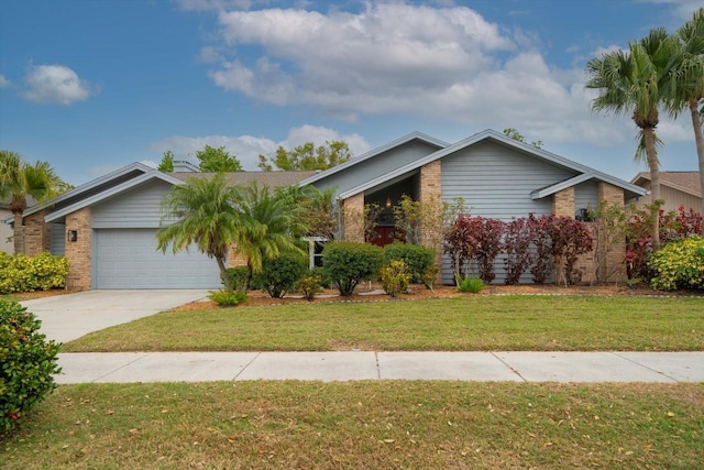 mid-century modern home featuring brick siding, driveway, an attached garage, and a front lawn