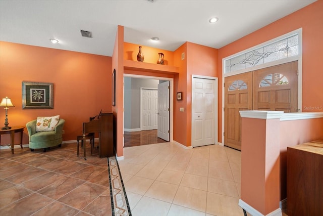 entryway with light tile patterned floors, visible vents, recessed lighting, and baseboards