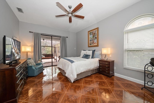 bedroom featuring visible vents, lofted ceiling, access to exterior, baseboards, and ceiling fan