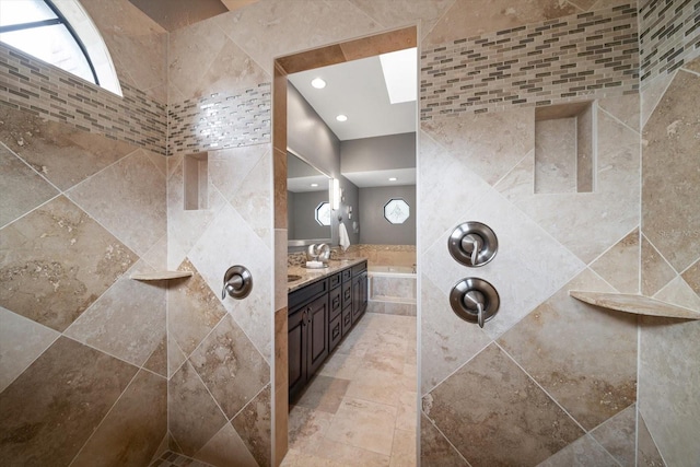 full bath featuring vanity, recessed lighting, and tiled shower