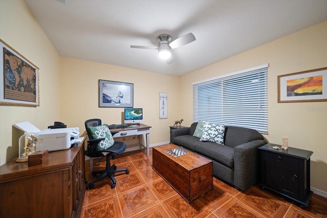 tiled office space with baseboards and ceiling fan