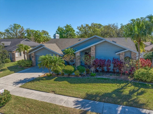 view of front of home featuring driveway, a shingled roof, a chimney, a front lawn, and a garage