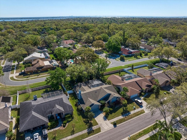 bird's eye view featuring a forest view and a residential view