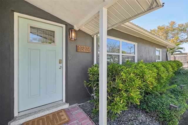 view of exterior entry featuring stucco siding