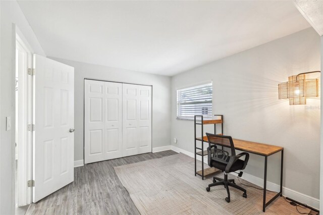 office featuring baseboards and wood finished floors