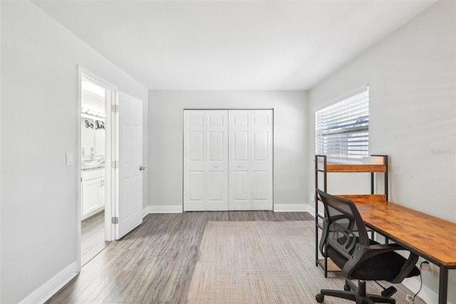 office featuring baseboards and wood finished floors