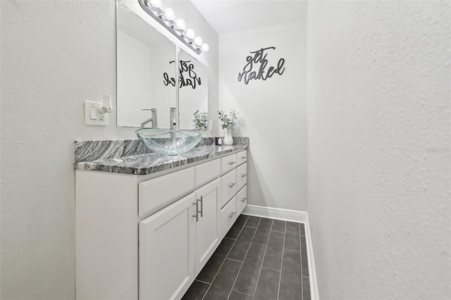 bathroom featuring baseboards and vanity