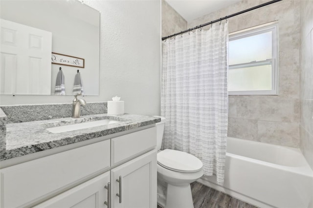 full bathroom with shower / bathtub combination with curtain, toilet, vanity, and wood finished floors