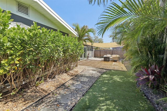 view of yard featuring a deck and fence