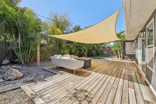 wooden deck with a fenced backyard