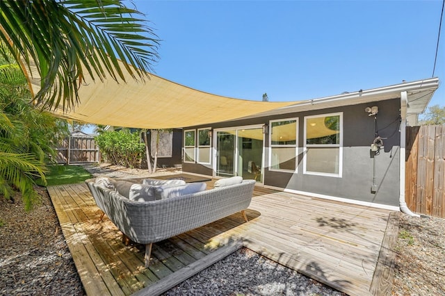 deck featuring an outdoor living space and fence