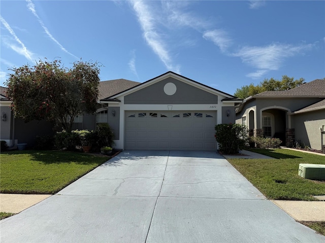 ranch-style house with a garage, stucco siding, concrete driveway, and a front yard