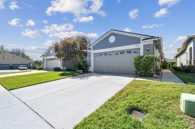 31820 Blythewood Way, Wesley Chapel, FL 33543 - single story home featuring a front lawn, stucco siding, driveway, and a garage