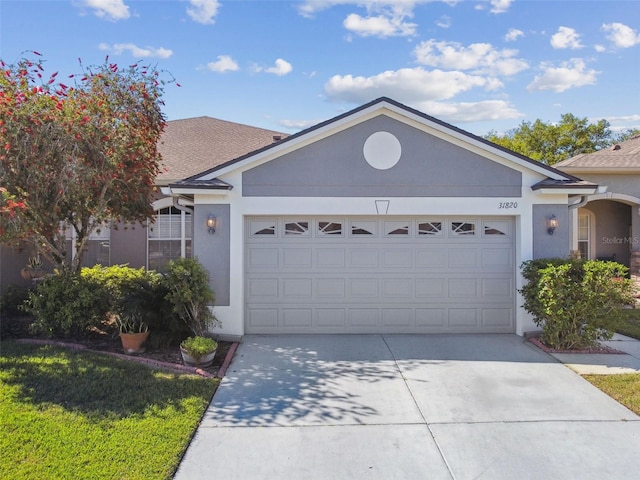 31820 Blythewood Way, Wesley Chapel, FL 33543 - ranch-style home with a garage, stucco siding, concrete driveway, and roof with shingles