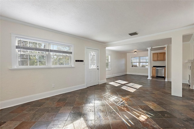 foyer featuring stone tile floors, baseboards, and ornamental molding