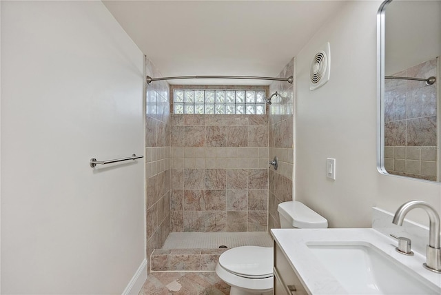 full bathroom featuring vanity, toilet, visible vents, and a tile shower