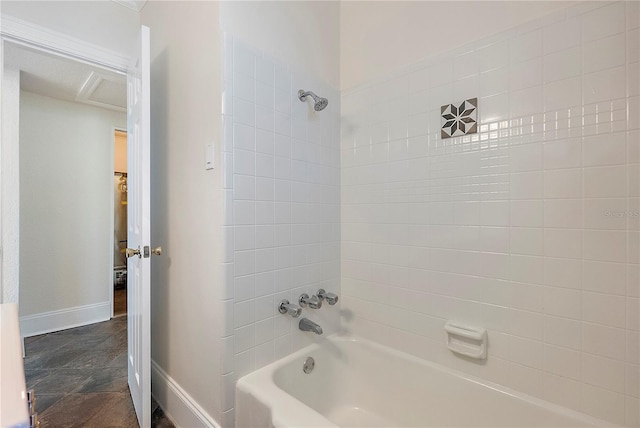 full bath with stone finish flooring, baseboards, and shower / tub combination