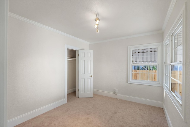 unfurnished bedroom featuring light colored carpet, baseboards, a closet, and ornamental molding