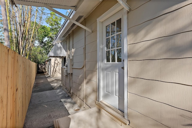 view of exterior entry with fence