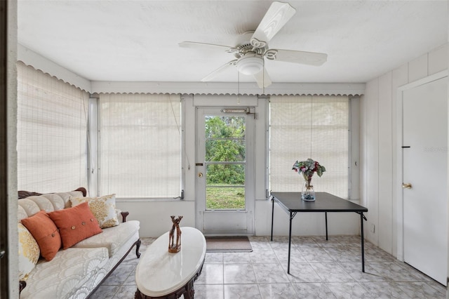 sunroom / solarium with a ceiling fan