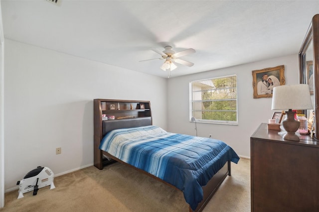 carpeted bedroom featuring a ceiling fan and baseboards