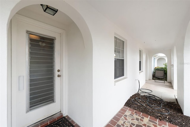 property entrance with stucco siding