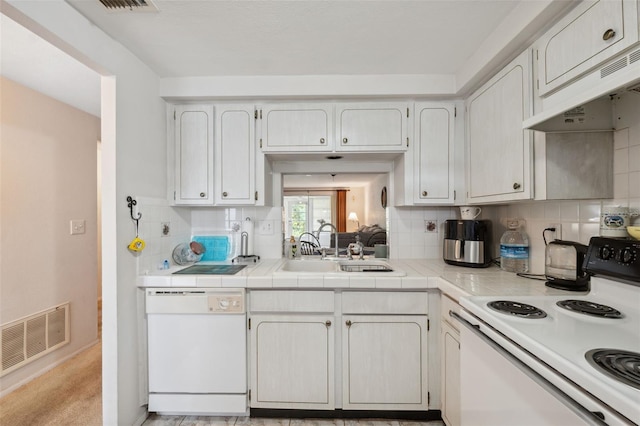 kitchen featuring under cabinet range hood, visible vents, white appliances, and decorative backsplash