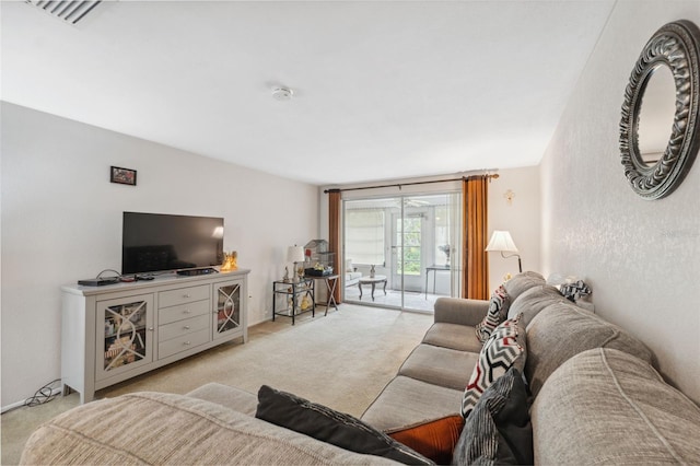 living room with visible vents and light colored carpet