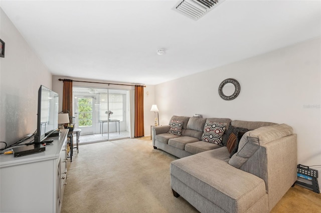 living room with visible vents and light carpet