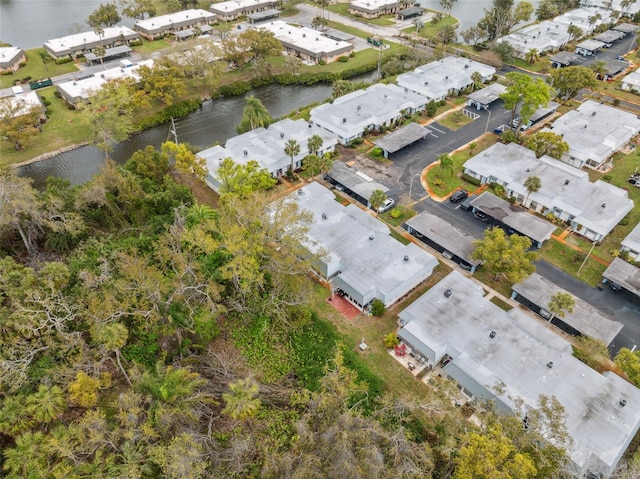 drone / aerial view with a residential view and a water view