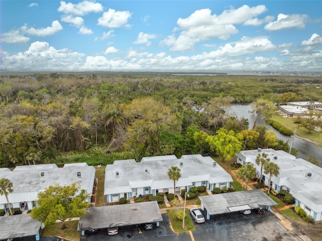 aerial view with a forest view and a water view