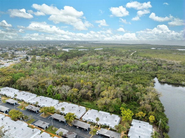 aerial view featuring a water view and a wooded view