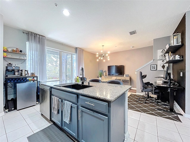 kitchen featuring visible vents, open floor plan, light tile patterned floors, stainless steel dishwasher, and a sink