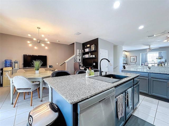 kitchen featuring a sink, stainless steel dishwasher, open floor plan, and light tile patterned floors