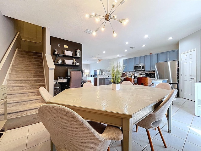 dining room featuring light tile patterned floors, visible vents, an inviting chandelier, recessed lighting, and stairs