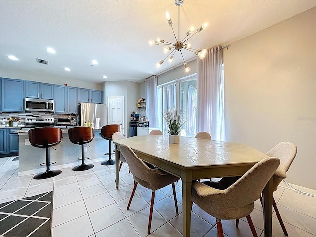 dining space with light tile patterned floors, baseboards, visible vents, recessed lighting, and a notable chandelier