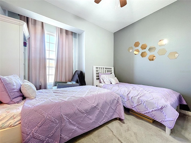 bedroom with a ceiling fan and carpet