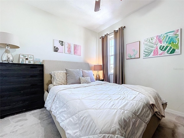 bedroom featuring ceiling fan, baseboards, and light carpet