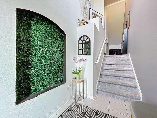 staircase with tile patterned floors and baseboards