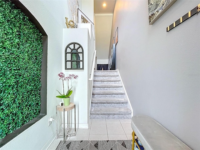 staircase with tile patterned flooring and baseboards