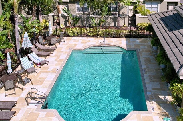 community pool featuring a patio area and fence