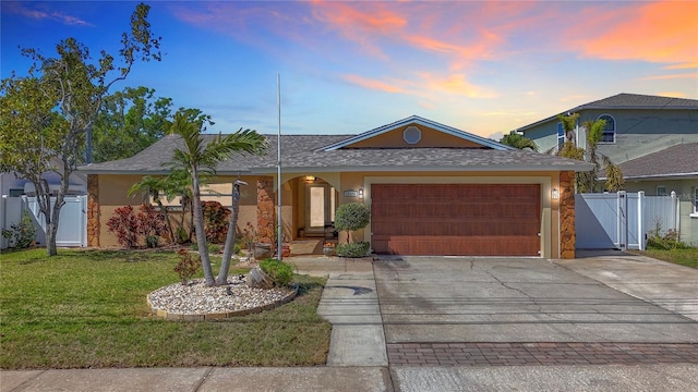 single story home featuring a front lawn, fence, concrete driveway, a garage, and a gate