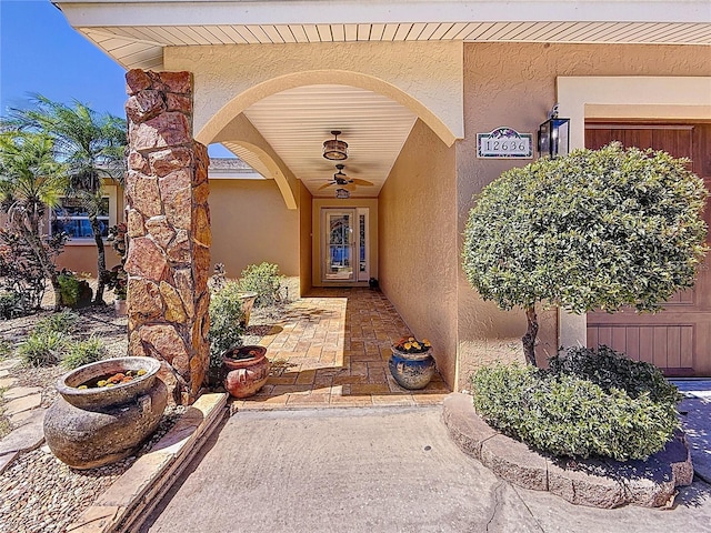 entrance to property featuring stucco siding