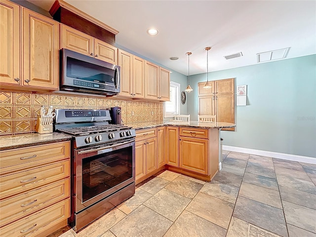 kitchen with decorative backsplash, a peninsula, light stone countertops, and stainless steel appliances