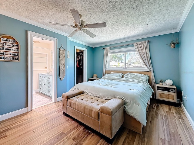 bedroom with a textured ceiling, light wood-style floors, and ornamental molding