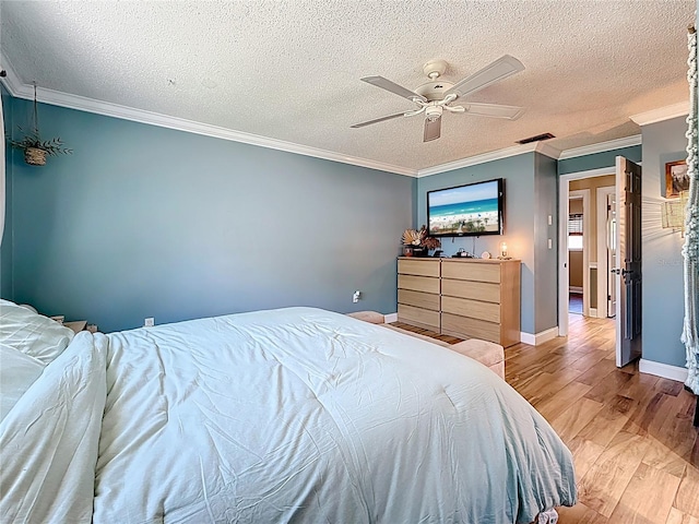 bedroom with a ceiling fan, a textured ceiling, light wood-style floors, crown molding, and baseboards