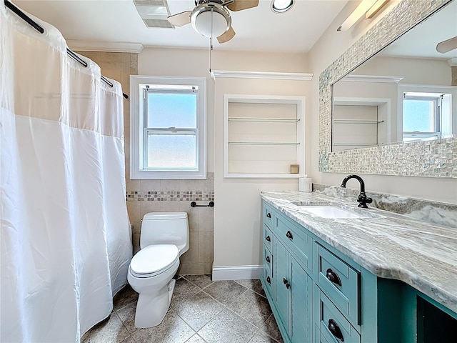 full bath featuring toilet, a ceiling fan, tile walls, baseboards, and vanity