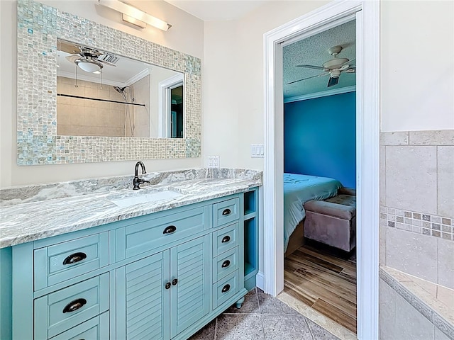 full bathroom with ceiling fan, ornamental molding, and vanity