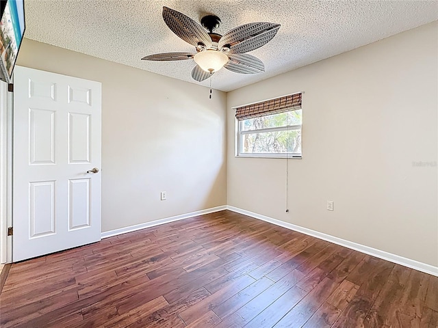 unfurnished room featuring baseboards, a textured ceiling, a ceiling fan, and wood finished floors