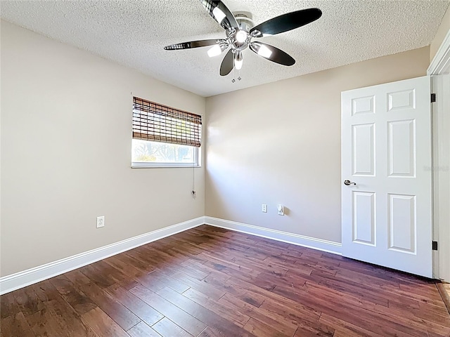 spare room featuring a ceiling fan, wood finished floors, baseboards, and a textured ceiling